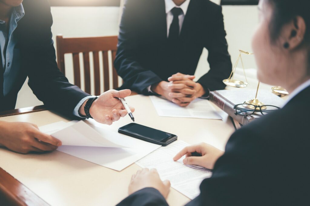 Lawyer and attorney having team meeting at law firm. | Benefits Of Attorney Fee Deferrals | Amicus Capital Group, Santa Clarita, CA